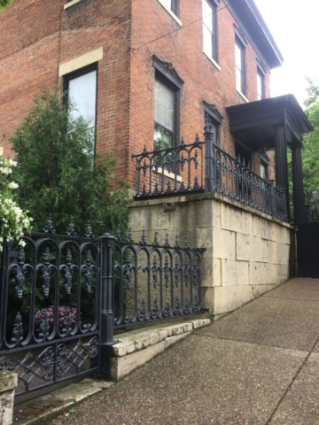 House on Bench Street with wrought iron fence and side garden