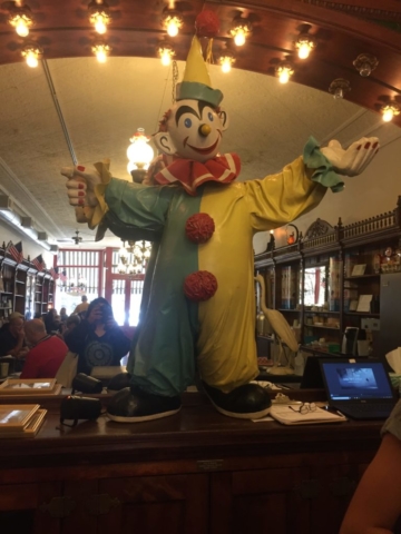 Statue of clown with raise arm inside ice cream parlor galena